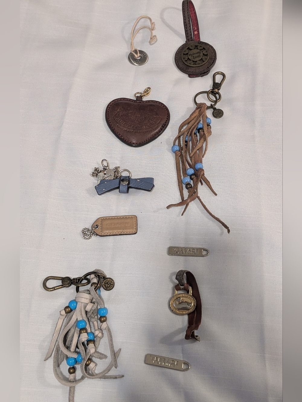 Lot of 10 brand name tags, Versace, coach,the sak,Dooney & Bourne, juicy couture